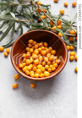 Sea buckthorn berries in bowl, harvesting healthy superfood Sea buckthorn berries in bowl, harvesting healthy superfood 131684791