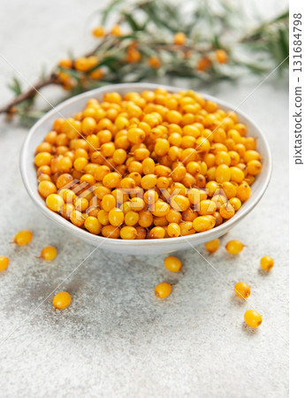 Sea buckthorn berries in bowl with branches Sea buckthorn berries in bowl with branches 131684798