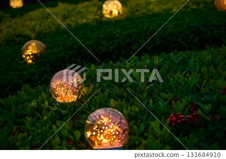 Lighting decoration in the garden at night. Glowing lamp. Copy space.  131684910