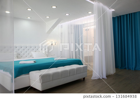 Four-poster bed. Protection from light and midges. Cozy bedroom in bright colors. Holiday apartments. Concept of recreation and travel. 131684938