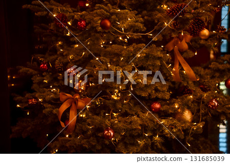 Close-up of the present boxes under the Christmas trees with colorful ornaments. Christmas presents, gifts. Festive decoration. Winter season, winter festive. Xmas celebration. For background use. Close-up of the present boxes under the Christmas trees with colorful ornaments. Christmas presents, gifts. Festive decoration. Winter season, winter festive. Xmas celebration. For background use. 131685039