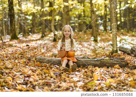 happy child girl throws autumn leaves and laughs outdoors happy child girl throws autumn leaves and laughs outdoors 131685088