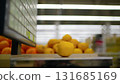 Lemon balancing on grocery store weighing scale 131685169
