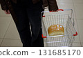 Person carrying grocery basket with fresh bread 131685170
