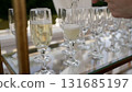 Waiter pouring champagne into glasses on a table for a celebration 131685197