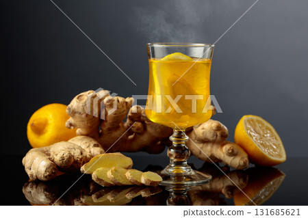Ginger tea with lemon on a black background. Ginger tea with lemon on a black background. 131685621
