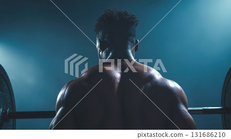 Strong man lifting weights in gym Strong man lifting weights in gym 131686210