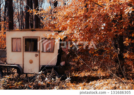 Abandoned Autumn Caravan Hidden in Golden Forest Abandoned Autumn Caravan Hidden in Golden Forest 131686305