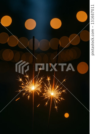 Sparklers glowing against bokeh lights for New Year holiday celebration 131687011