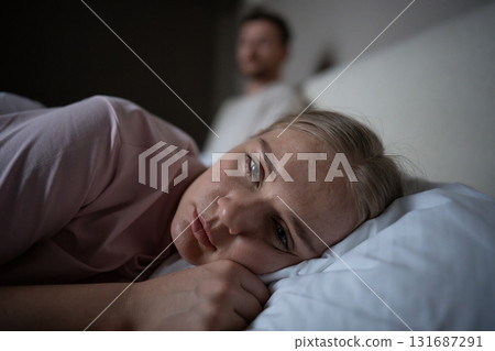 Sad disappointed woman turn away from husband in bed after conflict in relationship, intimacy issue Sad disappointed woman turn away from husband in bed after conflict in relationship, intimacy issue 131687291