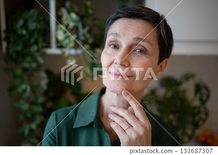 Happy calm European woman over fifty looking at camera graceful at home. Self assured female 131687307