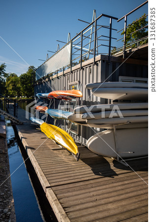 Urban SUP board rental service for water activities on rivers and canals. Aquatic sports activity 131687385