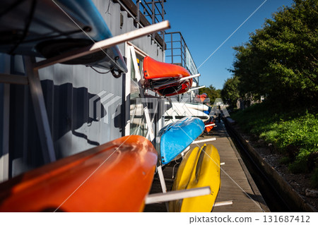 Urban paddleboarding hub providing equipment hire for active outdoor leisure on city waterways Urban paddleboarding hub providing equipment hire for active outdoor leisure on city waterways 131687412