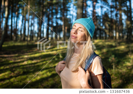 Calm woman stand with closed eyes in autumn forest, enjoying silence, relaxation. Mental recovery Calm woman stand with closed eyes in autumn forest, enjoying silence, relaxation. Mental recovery 131687436
