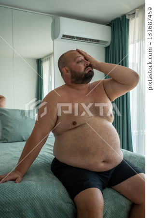 Fat guy suffers tortures from excessive sweating heat stuffiness summer abnormally high temperatures 131687459