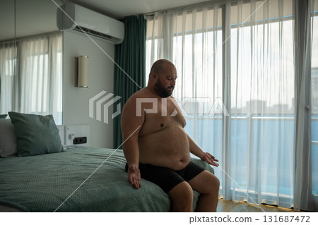 Overweight middle age man tries to normalize breathing. Extreme heat and suffocating stuffiness. Overweight middle age man tries to normalize breathing. Extreme heat and suffocating stuffiness. 131687472