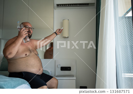 Obese male not tolerate summer weather suffocates from stuffiness. Fat man suffers dying from heat.  131687571
