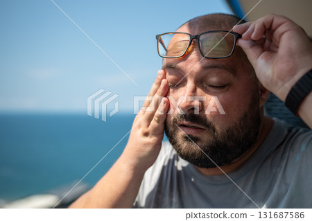 Overweight man wipes sweat face with suffering from summer sun sunstroke abnormally high temperature Overweight man wipes sweat face with suffering from summer sun sunstroke abnormally high temperature 131687586