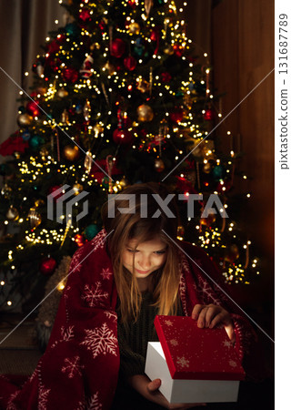 Christmas Surprise Moment with Gift Box. Excited Child Holding Red Christmas Present. holiday excitement, winter warmth, and joyful seasonal celebration Christmas Surprise Moment with Gift Box. Excited Child Holding Red Christmas Present. holiday excitement, winter warmth, and joyful seasonal celebration 131687789