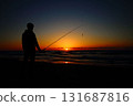 Sunset over the sea and a fisherman 131687816
