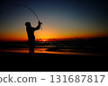Silhouette of a man fishing at sunset 131687817