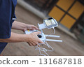 Worker operating a drone 131687818