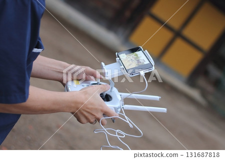 Worker operating a drone Worker operating a drone 131687818