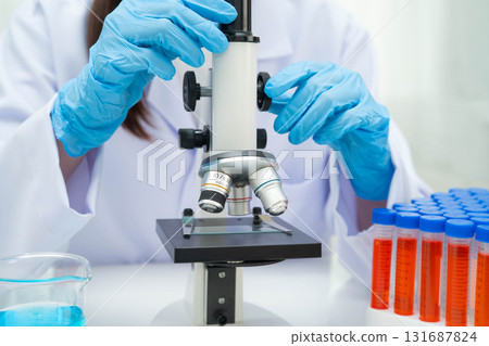 Scientist medical professional use microscope for research in science laboratory. 131687824