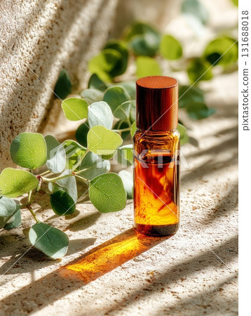 Essential oil bottle with eucalyptus branch for wellness 131688018