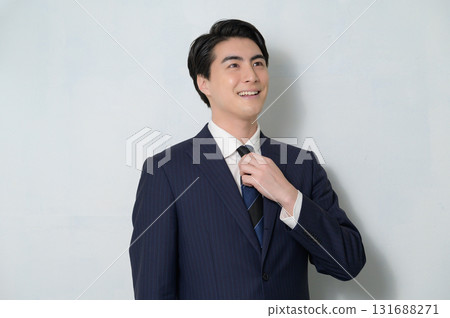 A man wearing a suit looking up on a white background A man wearing a suit looking up on a white background 131688271
