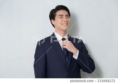 A man wearing a suit looking up on a white background A man wearing a suit looking up on a white background 131688272