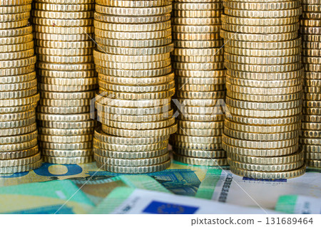 Stacks of euro coins and banknotes symbolizing finance, banking, savings, investment, and economy 131689464