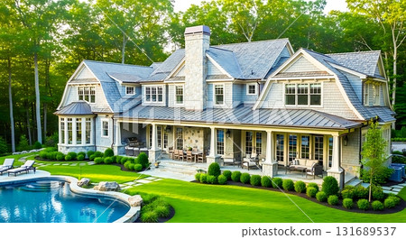 Aerial view of large house with pool and patio surrounded by lush greenery on a sunny day outside home 131689537