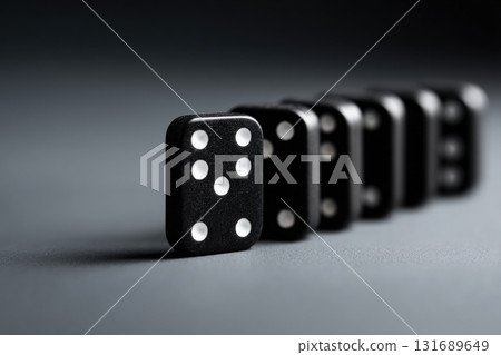 Dominoes lined up on a smooth surface creating a striking visual effect 131689649