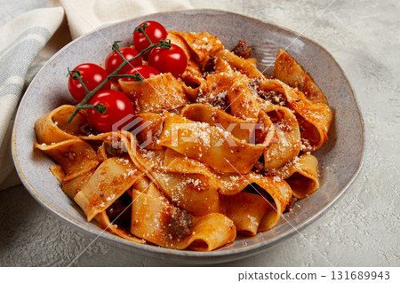 pappardelle pasta with bolognese sauce, topped with parmesan cheese and cherry branch, homemade, no people, 131689943