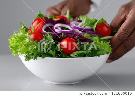 Fresh salad preparation with vibrant vegetables in a modern kitchen setting Fresh salad preparation with vibrant vegetables in a modern kitchen setting 131690010