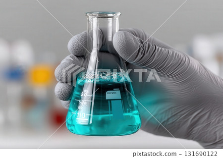 Chemistry experiment showcasing a person holding a flask with blue liquid in a laboratory setting 131690122