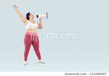 Young fat woman screaming with mouthpiece on studio blue background. Advertising concept. Young fat woman screaming with mouthpiece on studio blue background. Advertising concept. 131690467