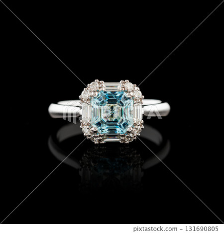 Beautiful white gold ring with diamonds and aquamarine on a black background 131690805