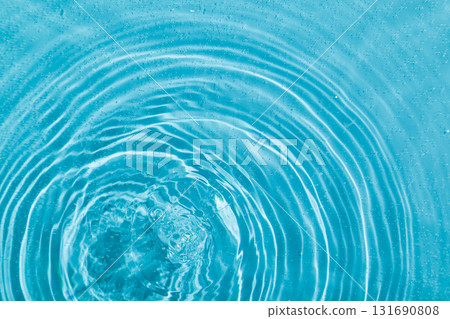 drops on water with circles on a blue background 131690808