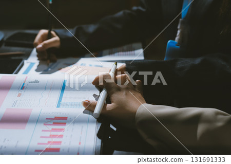 Close up high angle Asian businesswoman working with her coworker in meeting room Close up high angle Asian businesswoman working with her coworker in meeting room 131691333