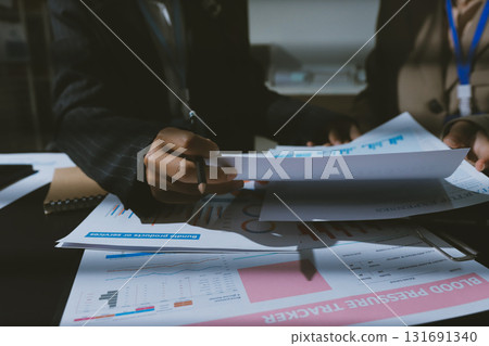 Close up high angle Asian businesswoman working with her coworker in meeting room Close up high angle Asian businesswoman working with her coworker in meeting room 131691340