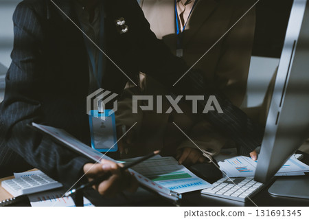 Close up high angle Asian businesswoman working with her coworker in meeting room Close up high angle Asian businesswoman working with her coworker in meeting room 131691345