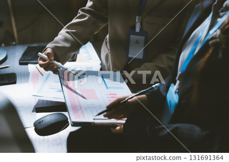 Close up high angle Asian businesswoman working with her coworker in meeting room 131691364