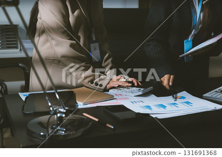 Close up high angle Asian businesswoman working with her coworker in meeting room 131691368