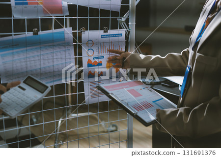 Close up high angle Asian businesswoman working with her coworker in meeting room 131691376