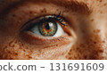 Close-up female eye with striking details and freckled skin. A macro shot showcases a human eye with a mesmerizing blend of colors, emphasizing the intricate  iris This is AI-generated item 131691609
