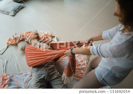 Yoga instructor prepares a class space with props and materials in a serene indoor studio environment during a morning session 131692054