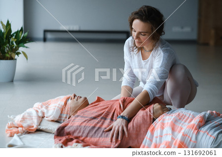 Relaxation and healing through gentle massage in a serene indoor setting during a wellness session 131692061