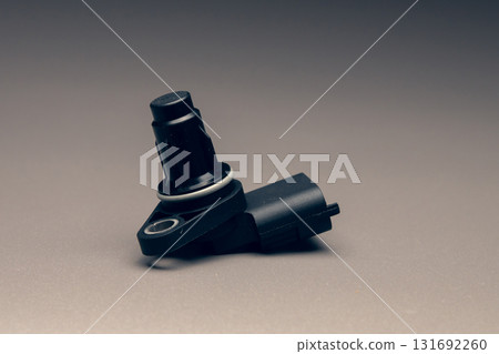 New black plastic crankshaft position sensor for an internal combustion engine on a gradient gray background New black plastic crankshaft position sensor for an internal combustion engine on a gradient gray background 131692260